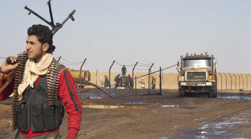 A Syrian rebel stands guard at an oil well near Shahel, Syria | David Enders/MCT Read more here: http://www.mcclatchydc.com/2012/12/02/176123/al-qaida-linked-group-syria-rebels.html#.UjQ_4n8X643#storylink=cpy