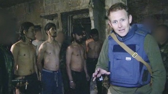 ITV News correspondent Dan Rivers with the defectors behind him Credit: ITV News