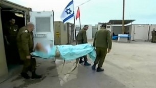 Israeli soldiers escort a wounded Syrian patient into a secret military field hospital in the Golan Heights. (photo credit: screen capture, Channel 2)